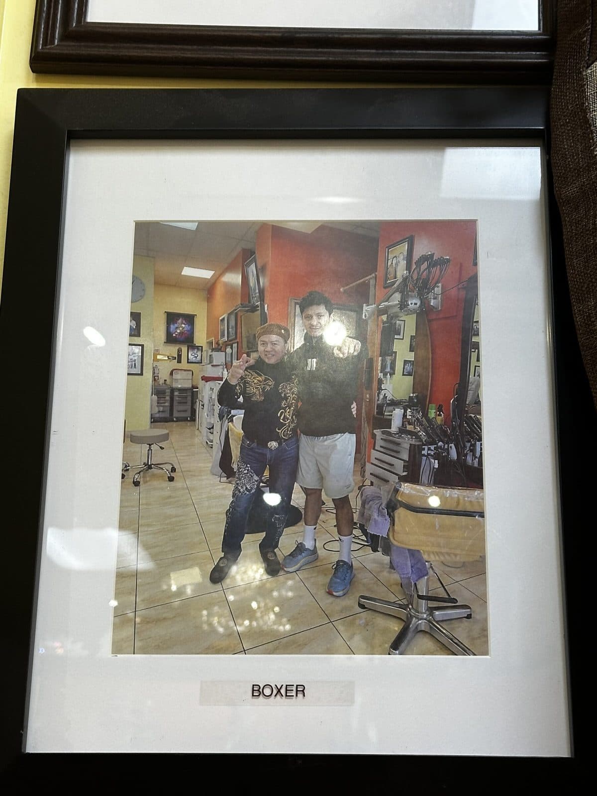Framed photo on the salon wall, labeled Boxer, a group inside the salon