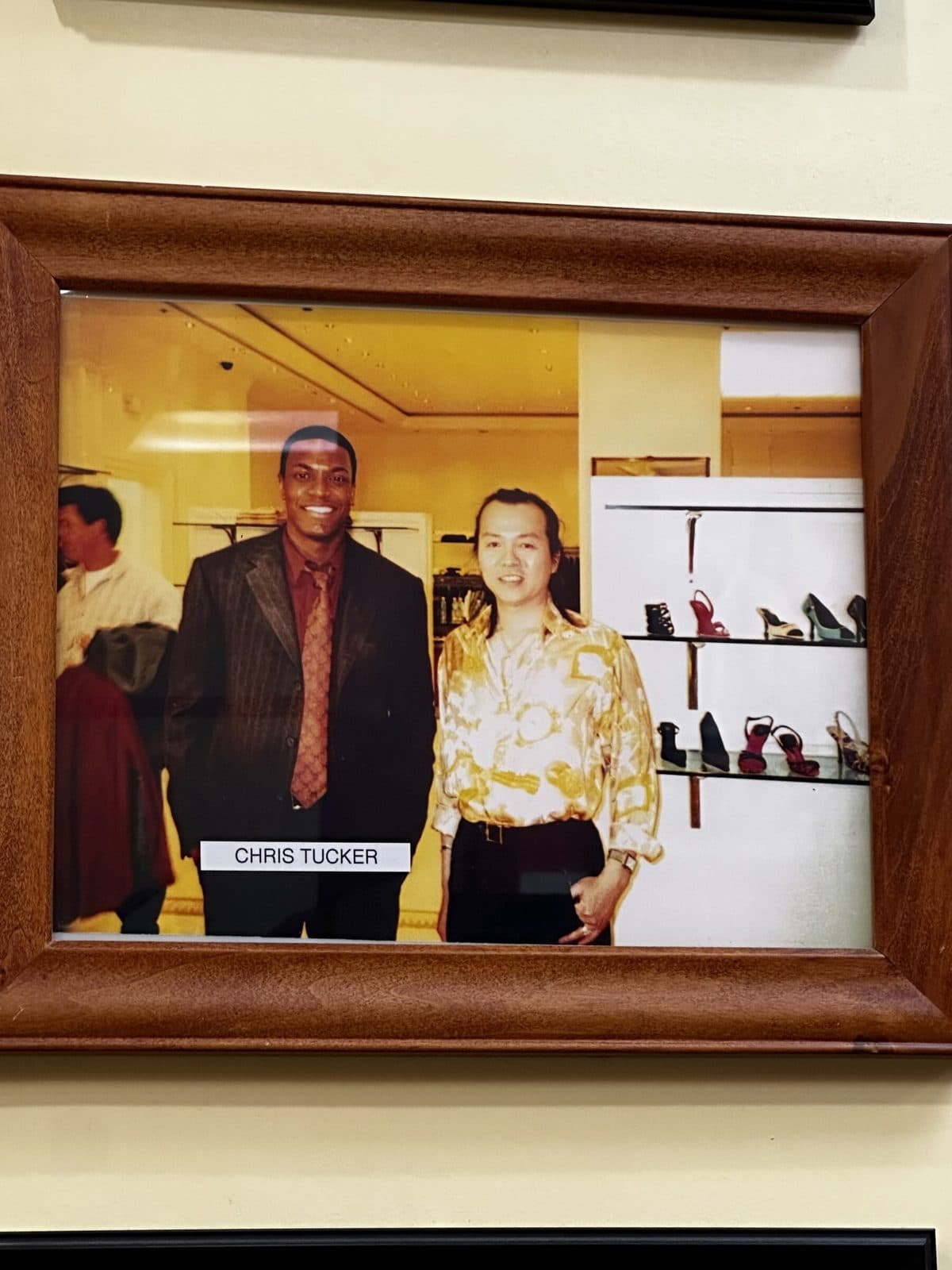 Framed photo in a wooden frame, labeled Chris Tucker