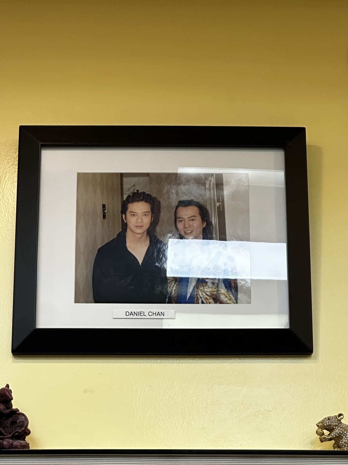 Framed photo on the salon wall, labeled Daniel Chan