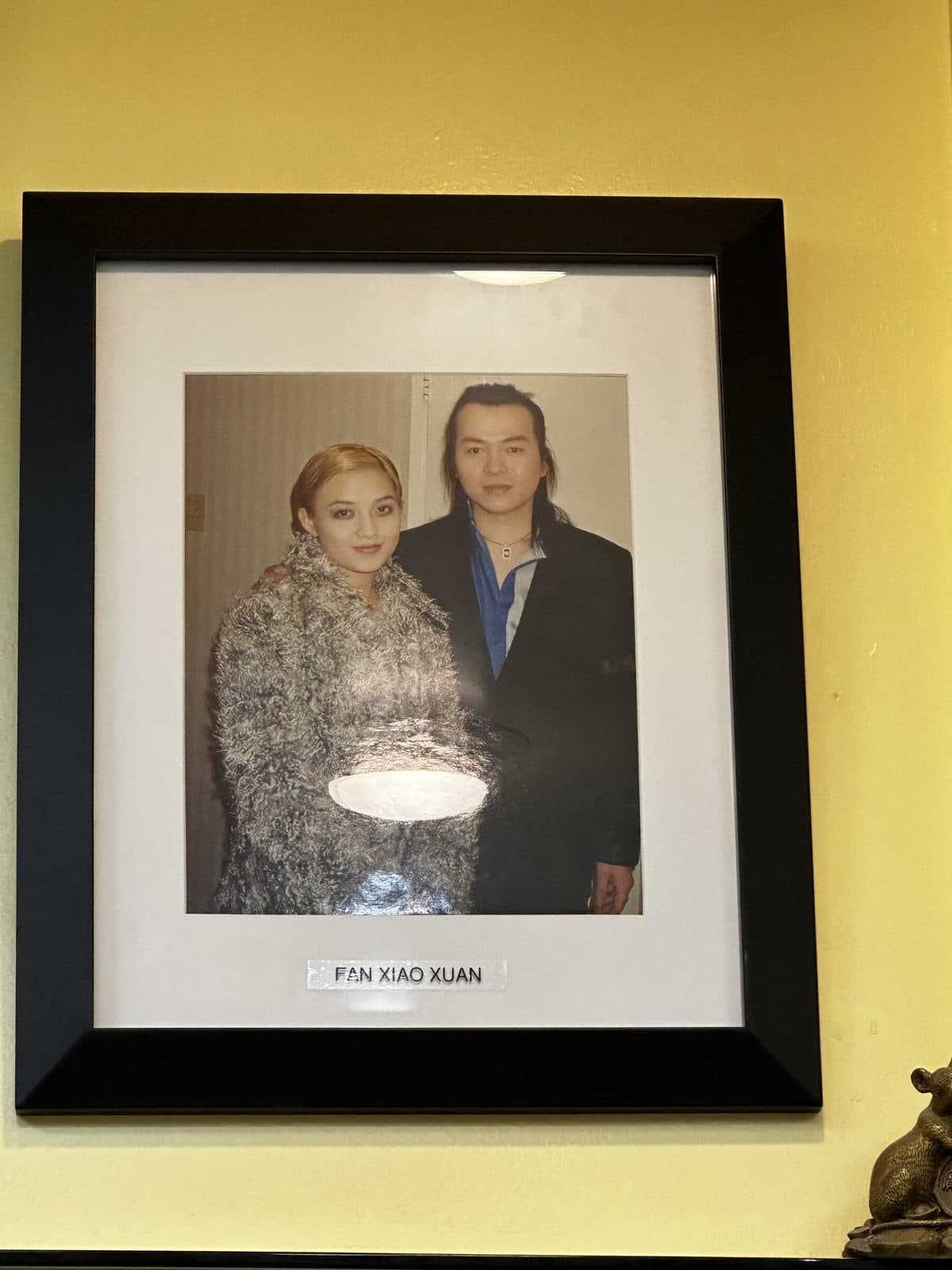 Framed photo on the salon wall, labeled Fan Xiao Xuan