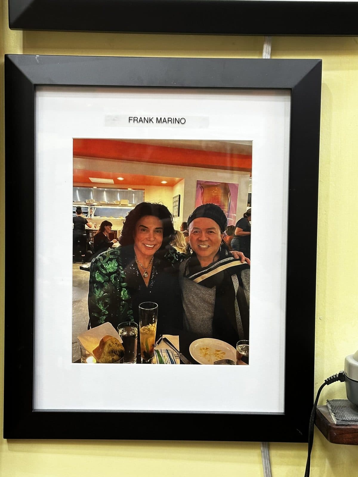 Framed photo on the salon wall, labeled Frank Marino