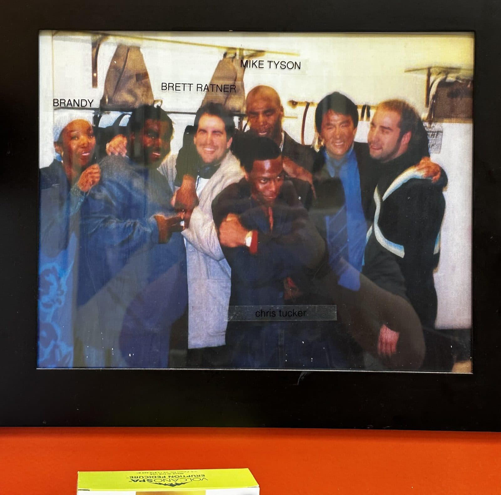 Framed group photo on the salon wall, labeled Brandy, Brett Ratner, Mike Tyson and Chris Tucker
