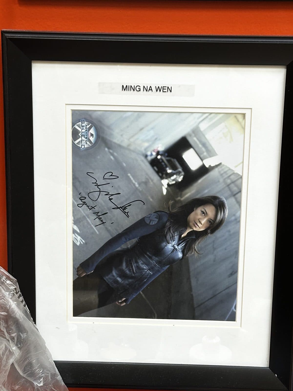 Signed photo on the salon wall, labeled Ming Na Wen